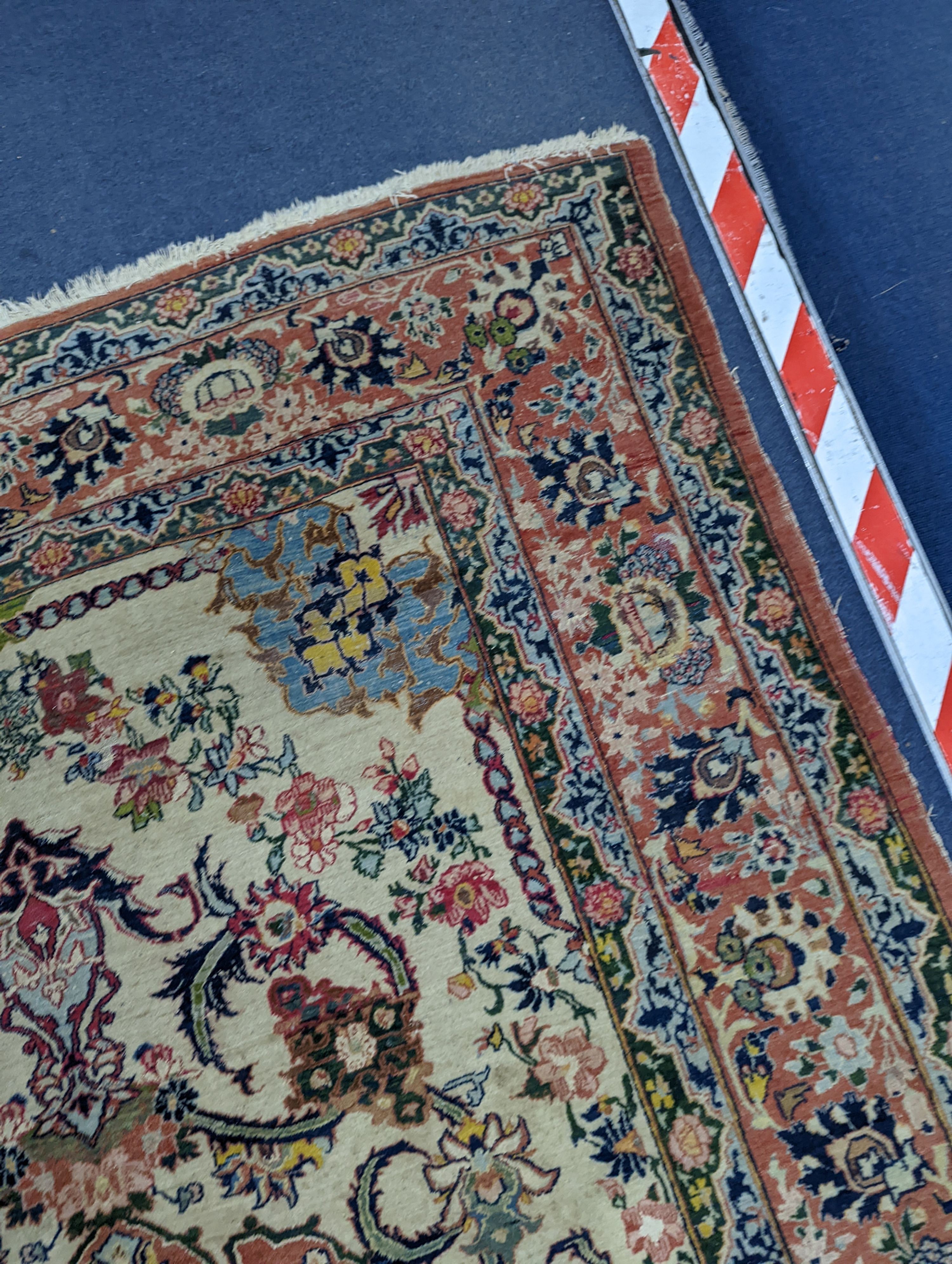 A part silk Isfahan cream rug with central floral scroll medallion, 196 x 140cm